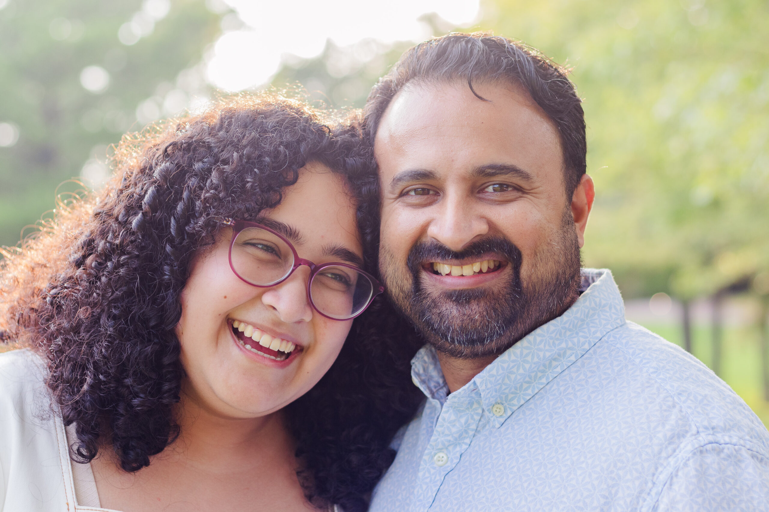 Father and adult daughter comfortable smiling